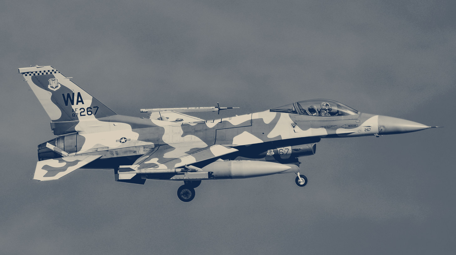 Two-tone photo of a 64th Aggressor Squadron F-16C in blue camouflage in flight during Red Flag 17-1 at Nellis Air Force Base, Nevada, 2017.