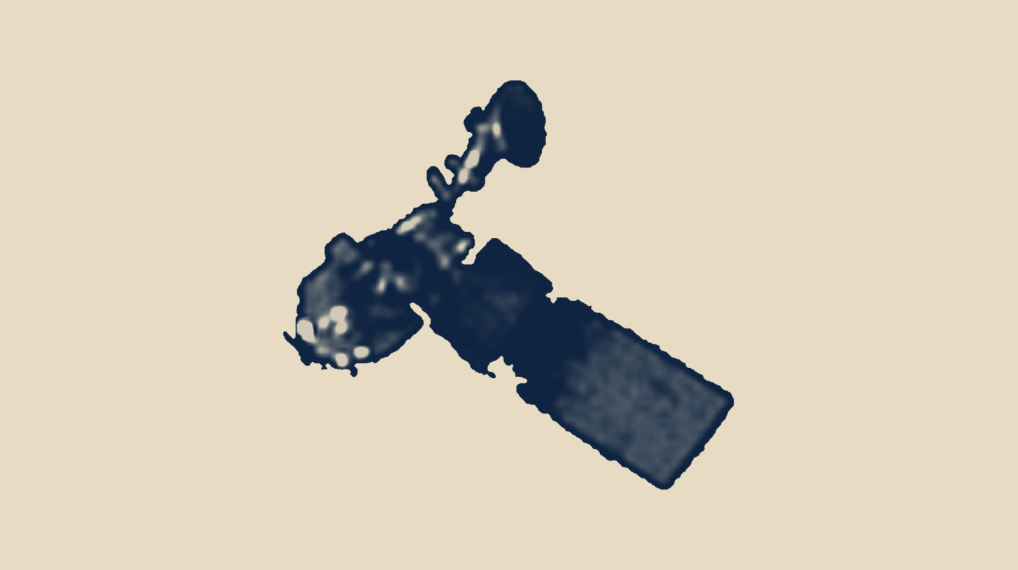 Two-tone BlackSky Gen-3 satellite image of the decommissioned Landsat 5 satellite in orbit, captured from space, on a plain sand background.