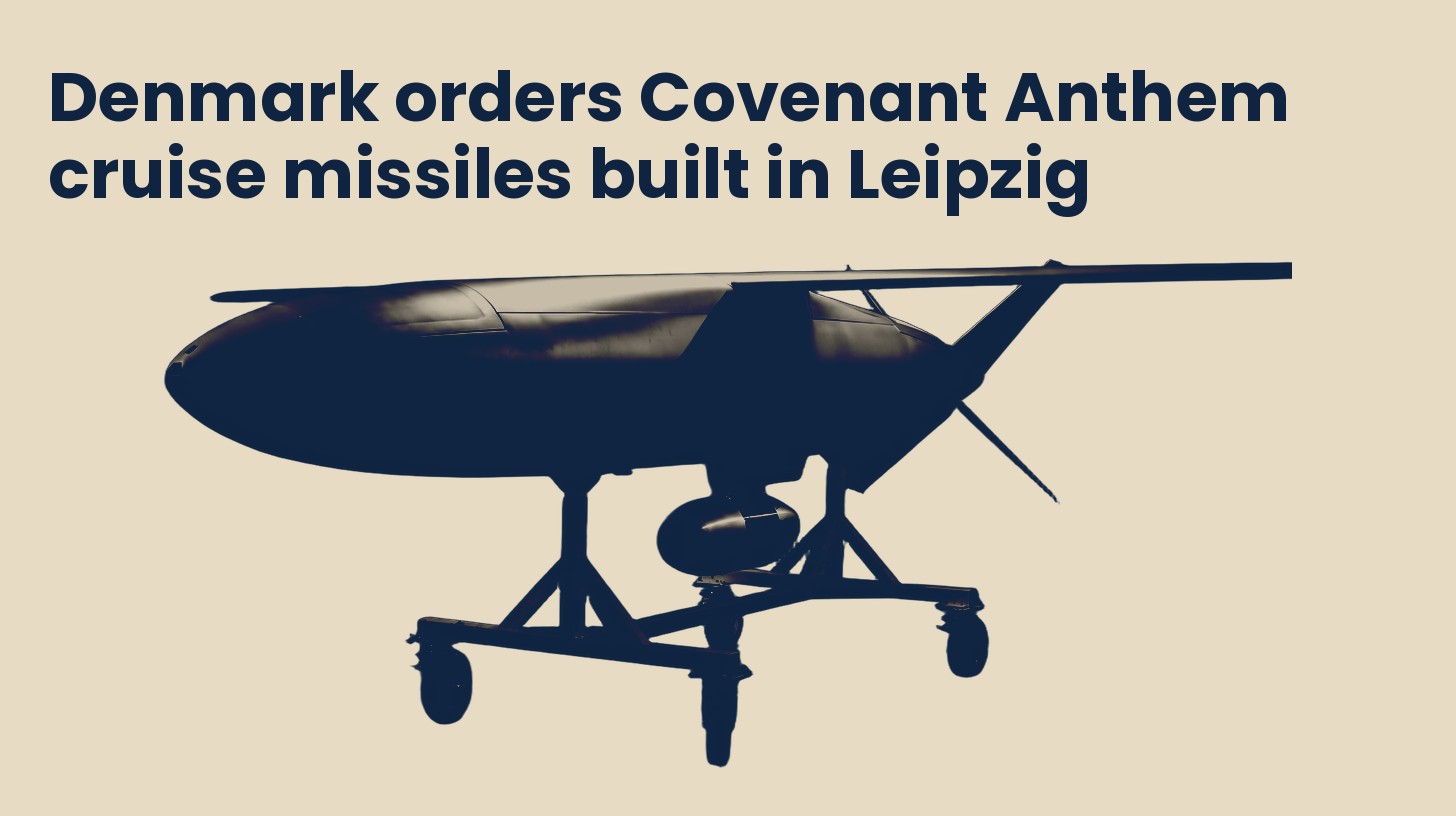 A Covenant cruise missile airframe resting on a wheeled transport stand, isolated on a plain sand background.