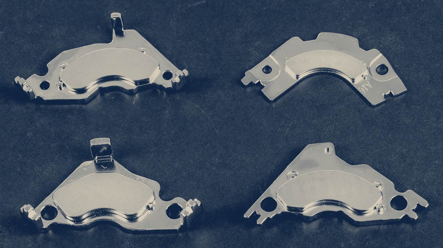 Two-tone photo of four neodymium magnets salvaged from hard drives, laid out on a dark background.