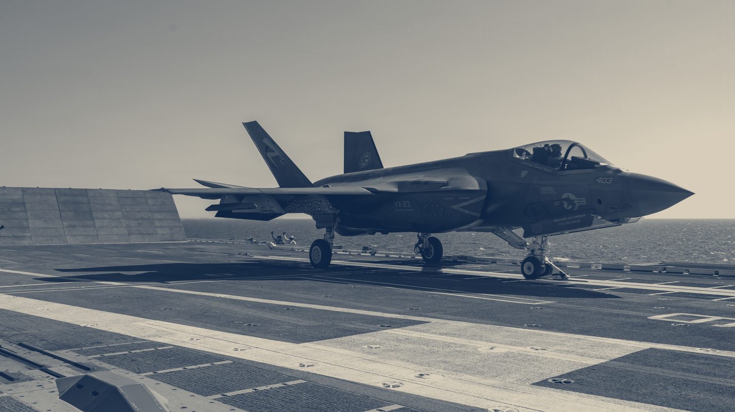 Two-tone U.S. Navy photo of an F-35C launching from the catapult of USS John F. Kennedy.
