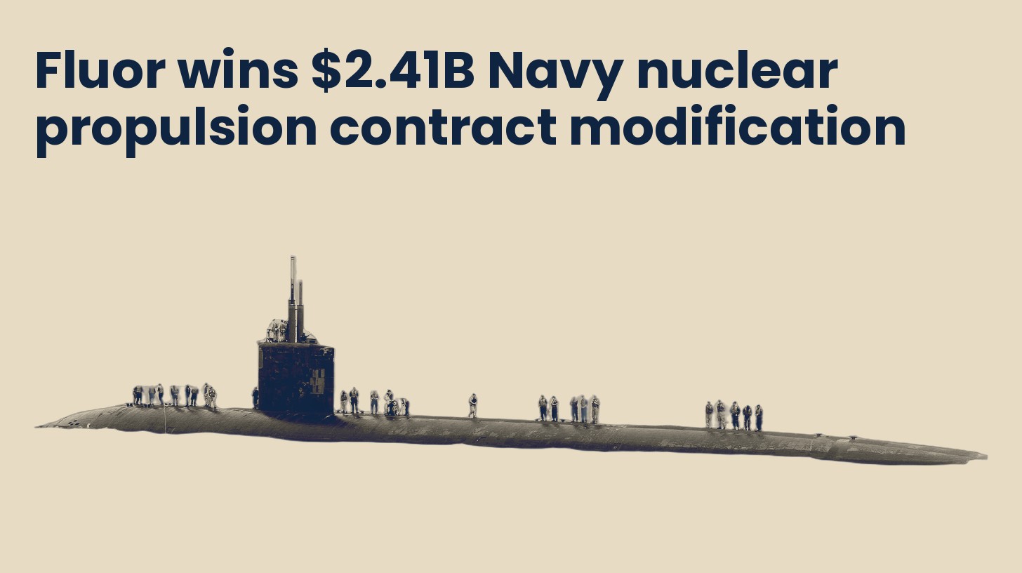 A Los Angeles-class attack submarine running surfaced, isolated on a plain sand background.
