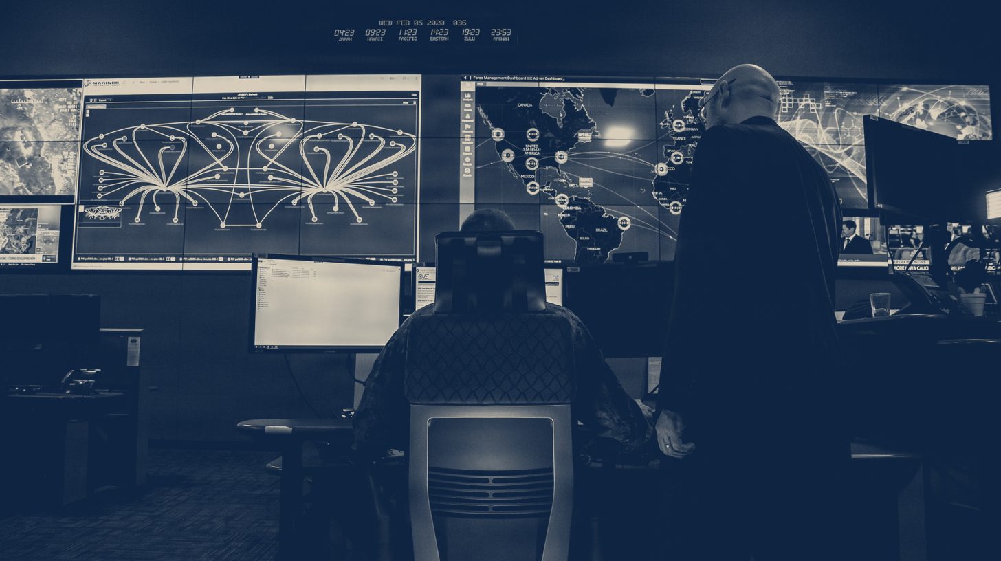 Two-tone 2020 U.S. Marine Corps photo of a cyber operations center at Fort Meade, a stand-in for the Leidos contract; the people shown are not Leidos staff.