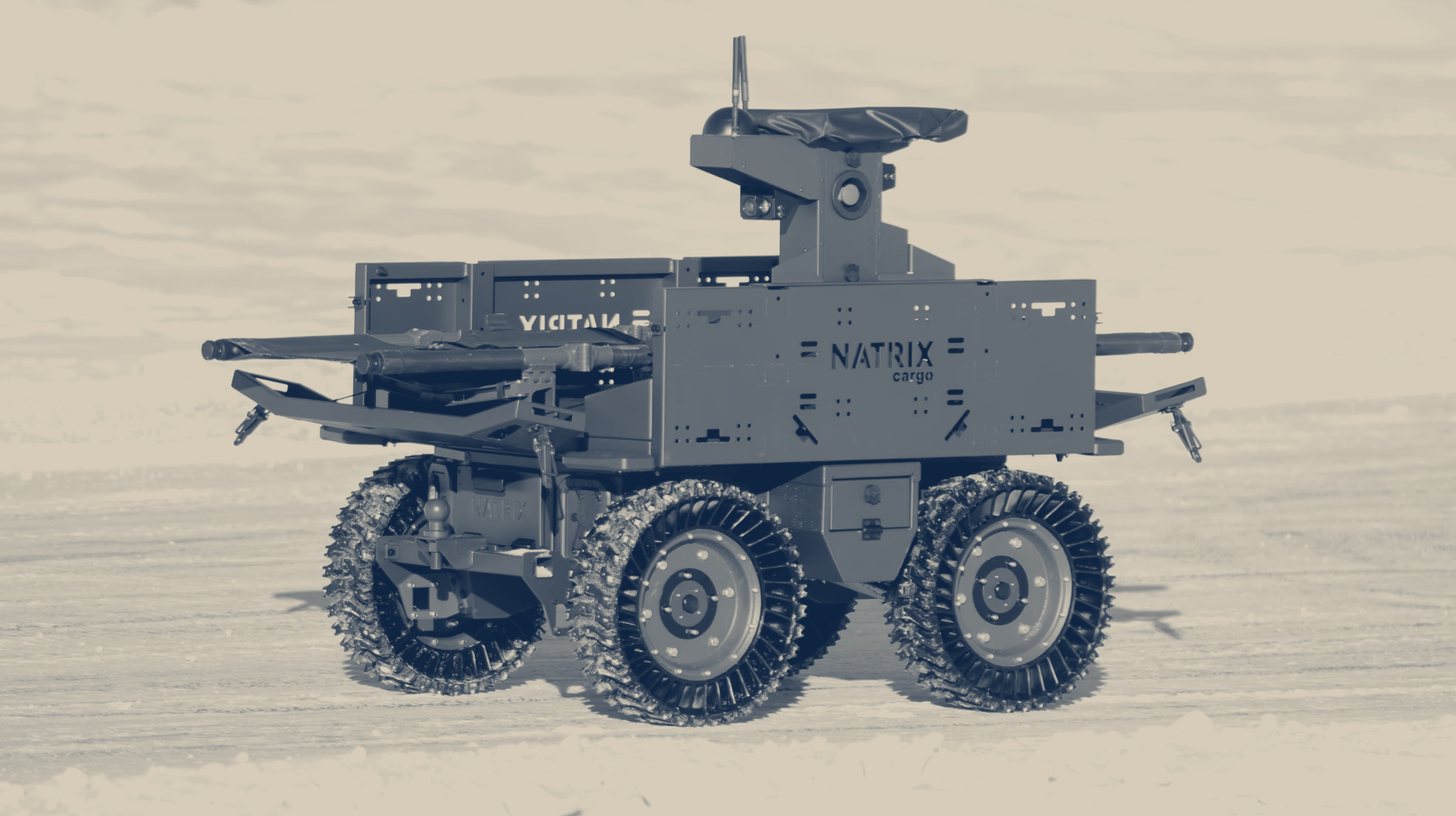 Two-tone NATRIX company photo of a NATRIX uncrewed ground vehicle with a remote weapon mount on snow.