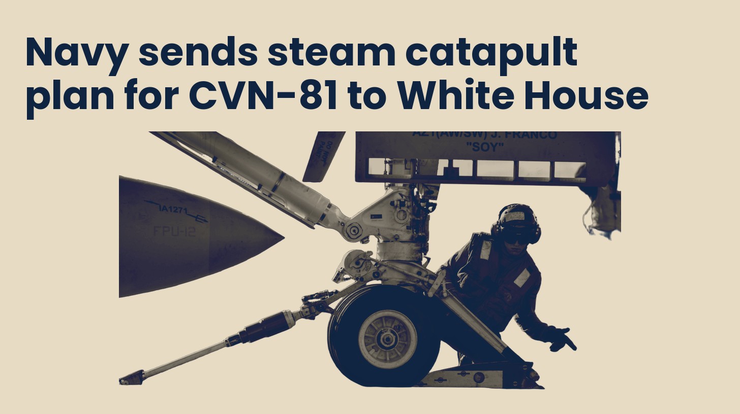 A flight deck sailor hooks an aircraft nose gear to the steam catapult shuttle, isolated on a plain sand background.