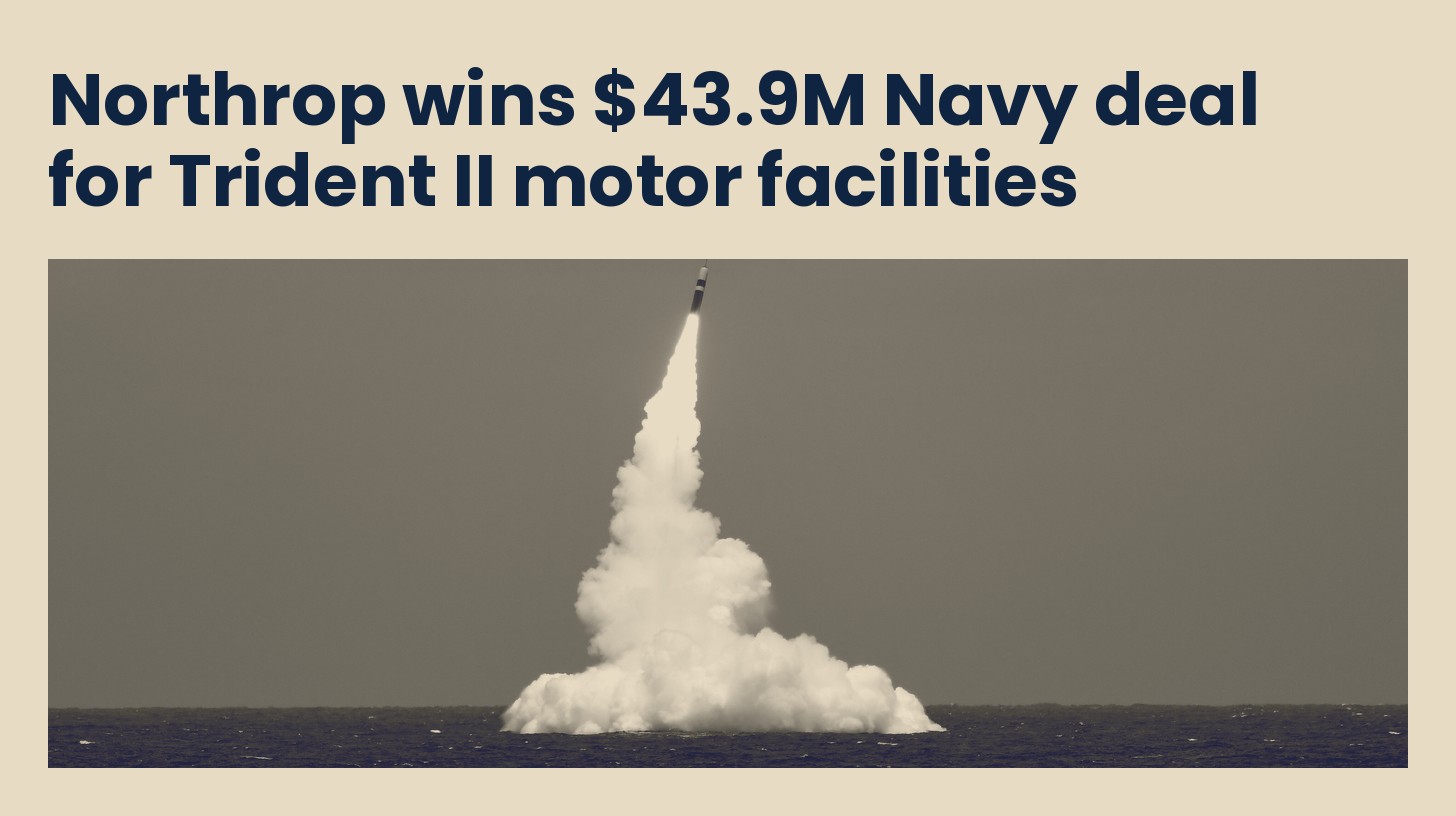 An unarmed Trident II D5 missile rising from the sea on a column of exhaust after launch from a submarine, in navy duotone.
