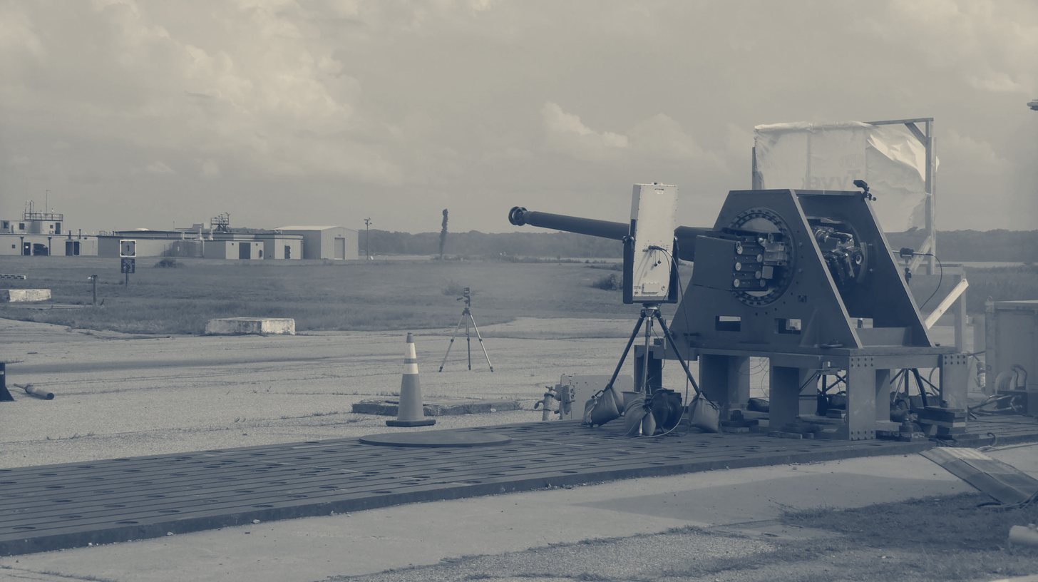 Two-tone Northrop Grumman company photo of a Raid Hunter gun-based counter-drone mount on a test range, a stand-in for the capacity expansion.