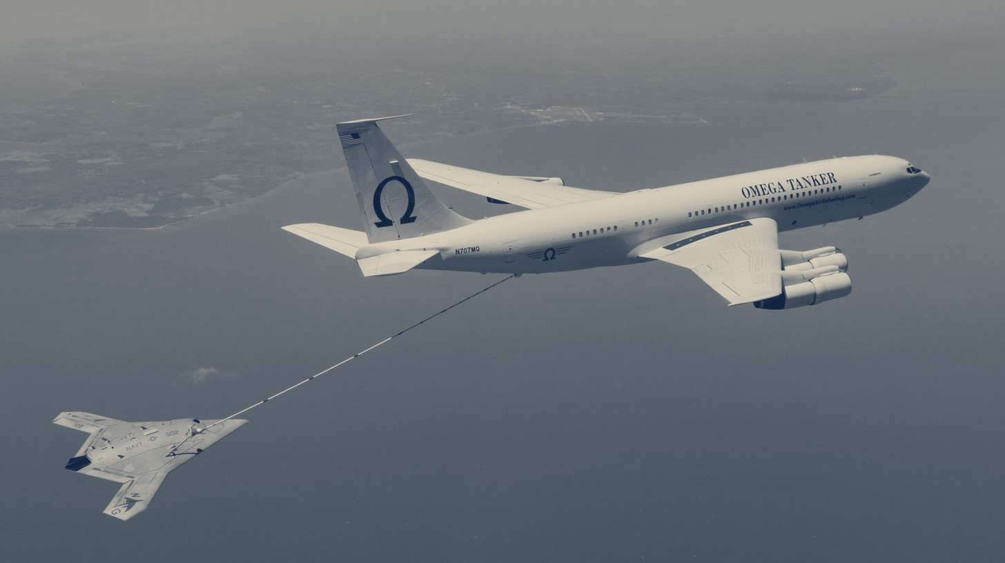 Two-tone older U.S. Navy photo of an Omega K-707 tanker refueling the X-47B drone over the Atlantic, not one of the KC-10s Omega acquired.