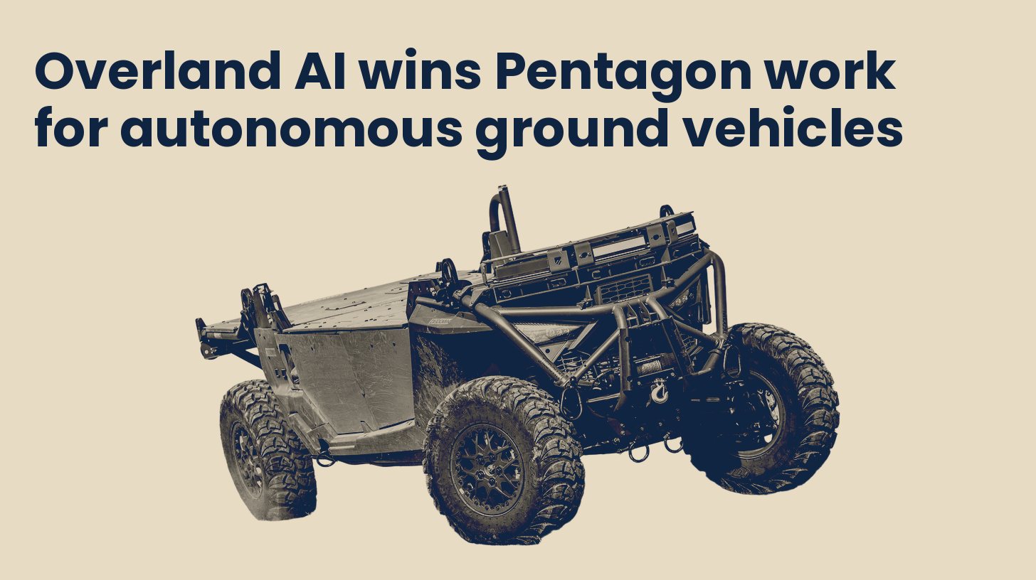 The Overland AI IBEX autonomous ground vehicle seen from the front three quarter view, isolated on a plain sand background.