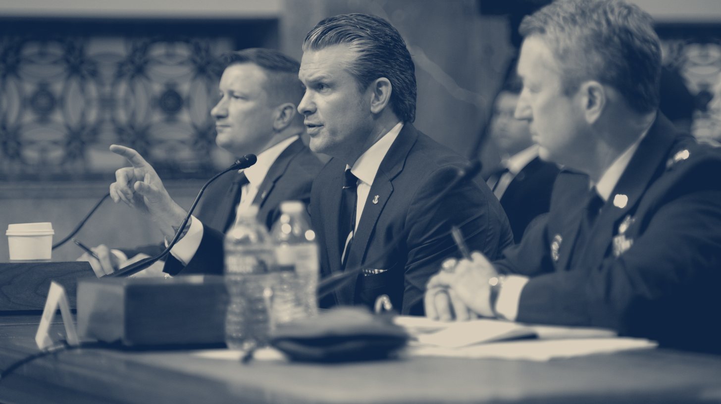 Two-tone DoW photo of Pete Hegseth at the witness table between DoD CFO Jules Hurst III and Gen. Dan Caine at a Senate Armed Services Committee FY27 budget hearing, April 30, 2026.