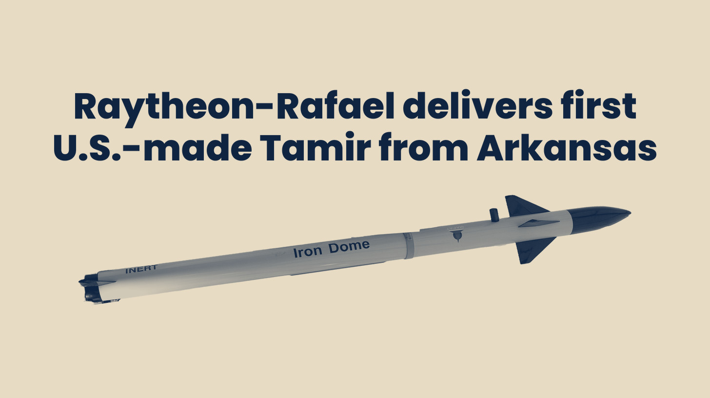 Two-tone photo of a full-size Tamir interceptor display model from the Rafael stand at the ILA Berlin 2012 air show, a trade-show article and not a U.S.-built round, turned on its side and cut out on a sand background below the headline "Raytheon-Rafael delivers first U.S.-made Tamir from Arkansas."