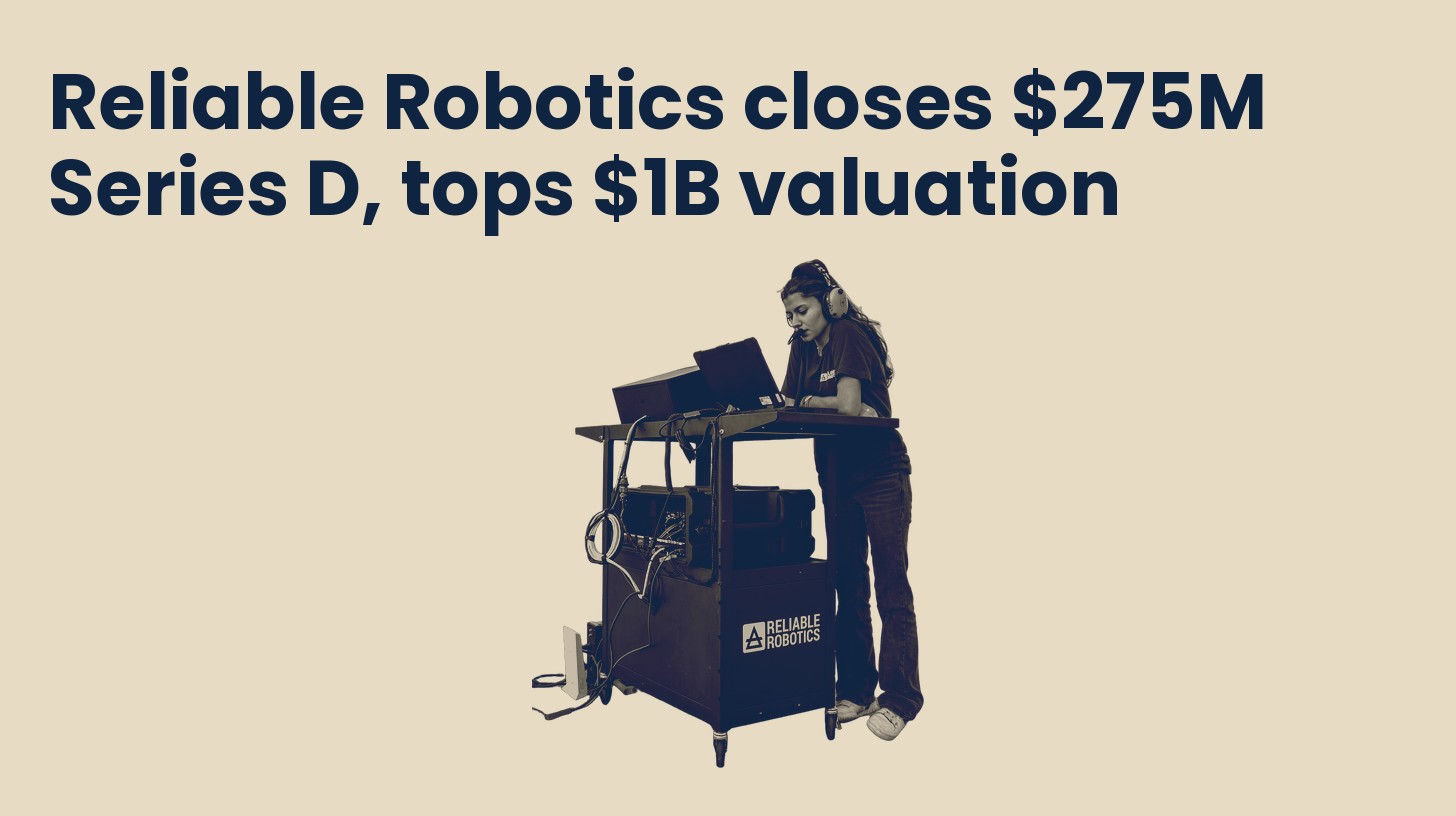A Reliable Robotics engineer wearing a headset works at a remote-pilot control cart, isolated on a plain sand background.