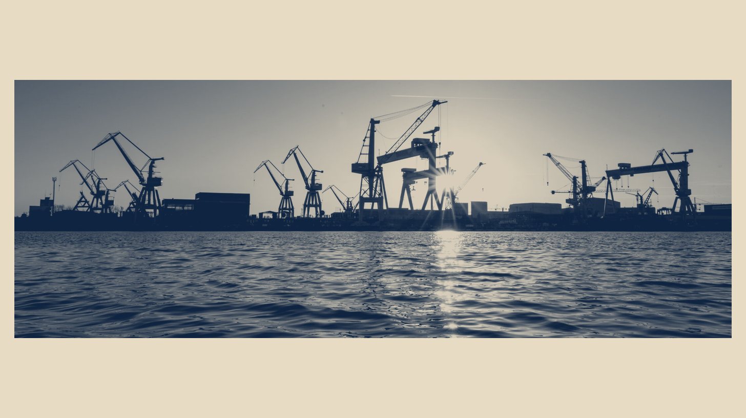 Two-tone Rheinmetall image of shipyard cranes silhouetted at sunset at Mangalia, Romania, shown as a wide panel on a plain sand background.
