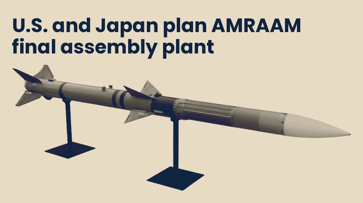 An AIM-120 AMRAAM air to air missile on display stands at the Smithsonian Udvar-Hazy Center, isolated on a plain sand background.
