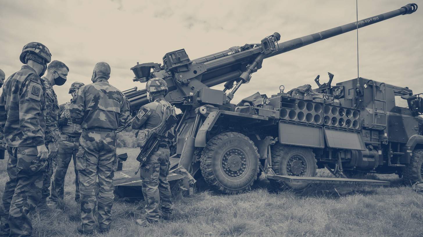 Two-tone U.S. Marine Corps photo of a French Army CAESAR wheeled howitzer and its crew, a rival in the same class rather than the Hanwha XM1776.