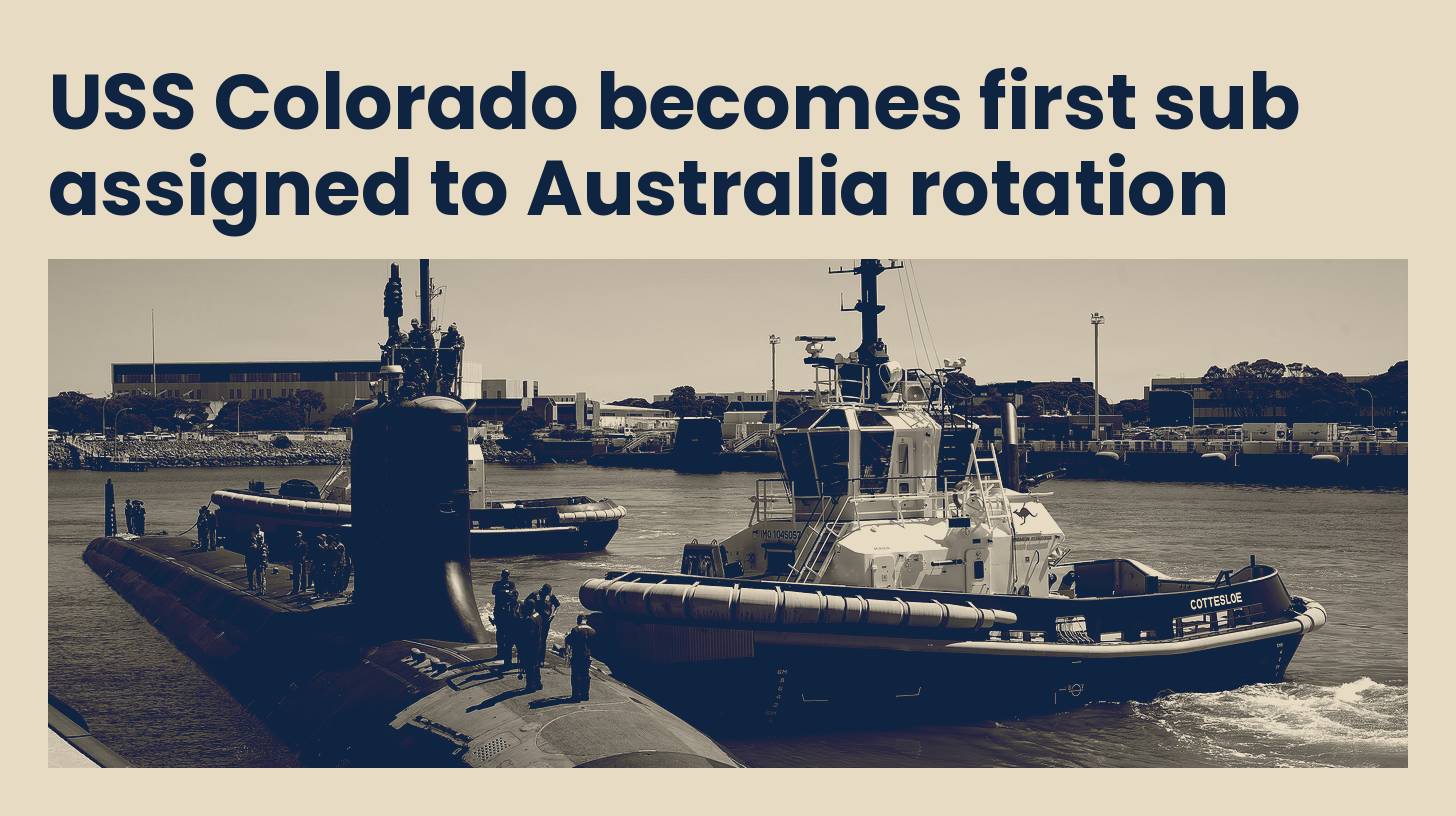 The submarine USS Colorado alongside a tug at HMAS Stirling in Western Australia, in navy and sand tones.