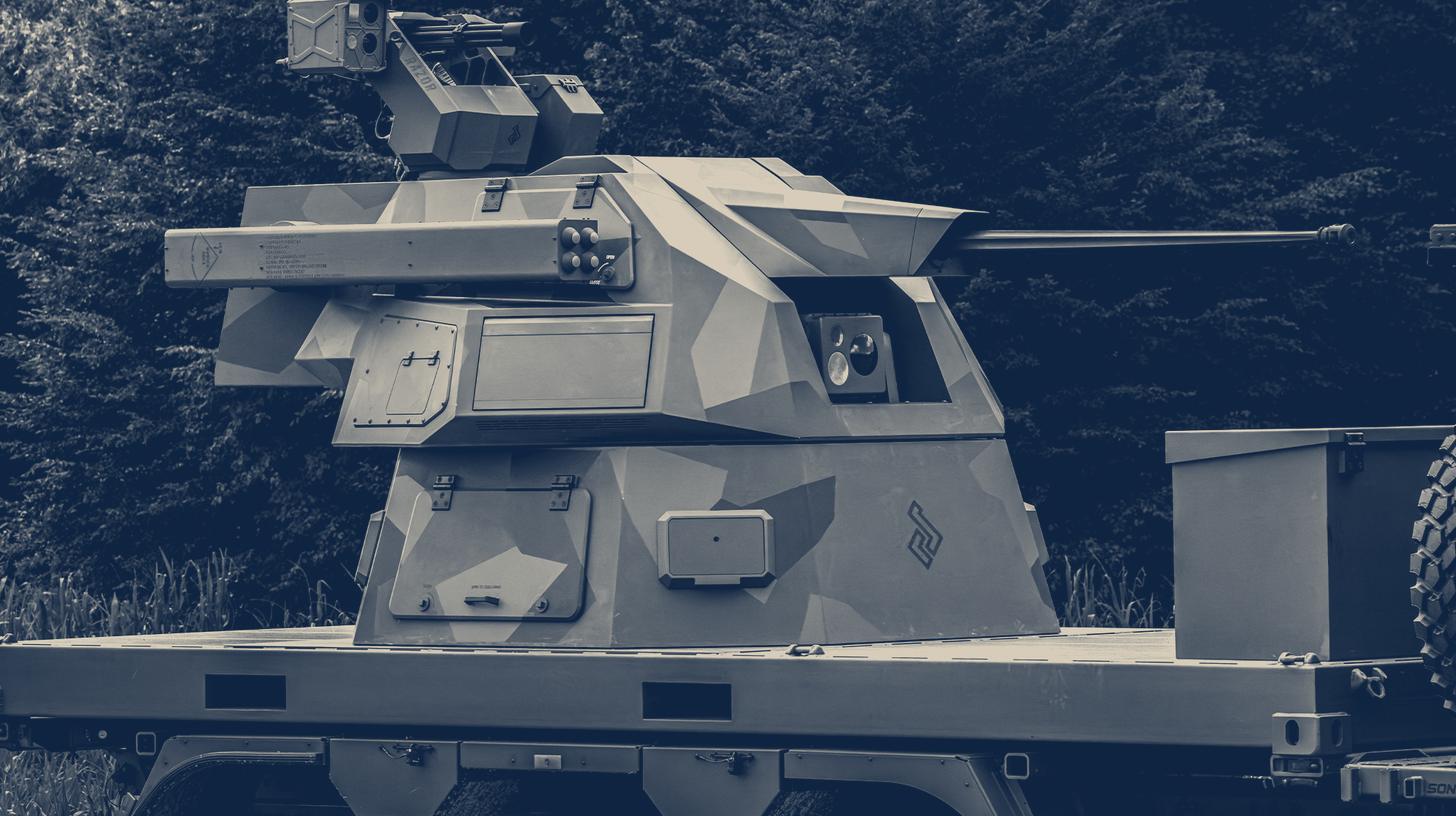 Two-tone Valhalla Turrets company image of the Skythunder 300 air defense turret mounted on a vehicle, an earlier version with a 30 mm cannon rather than the M197 Gatling gun.